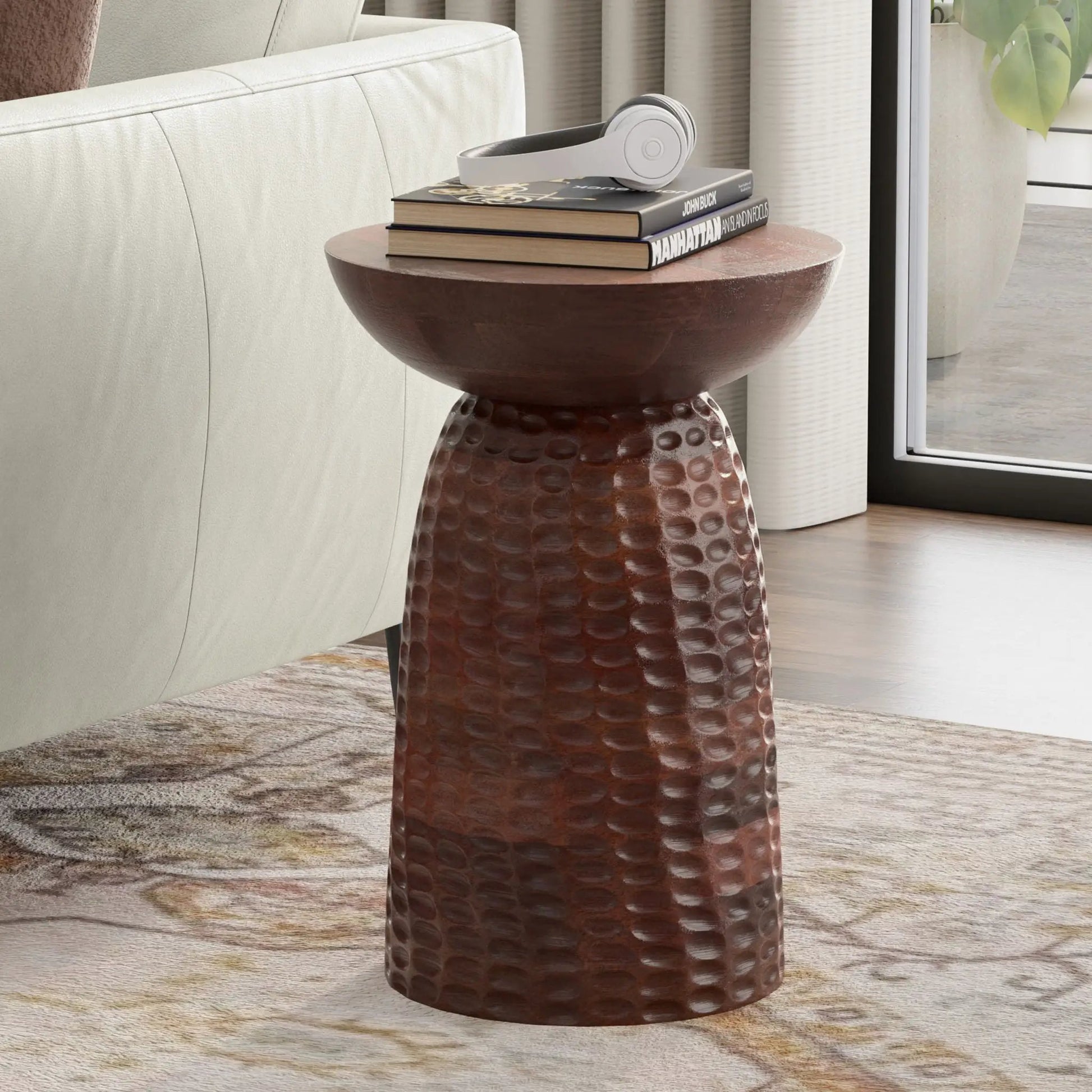 Boyd Handcrafted Accent Table copper hammered finish with 3 books and white headphones on Tampa Home & Garden Store