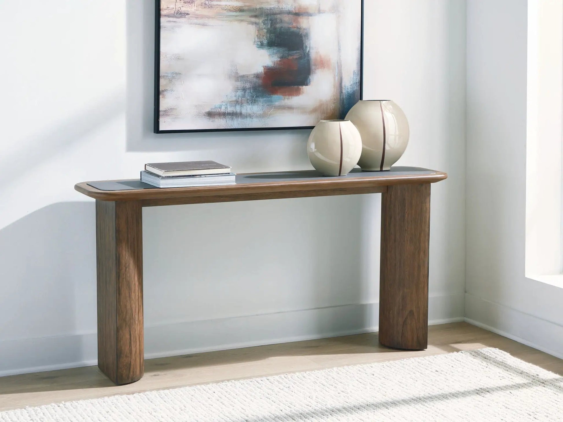 Dontayne sofa table by Unique Piece Furniture warm brown wood, rounded legs, two cream vases on Tampa Home & Garden Store