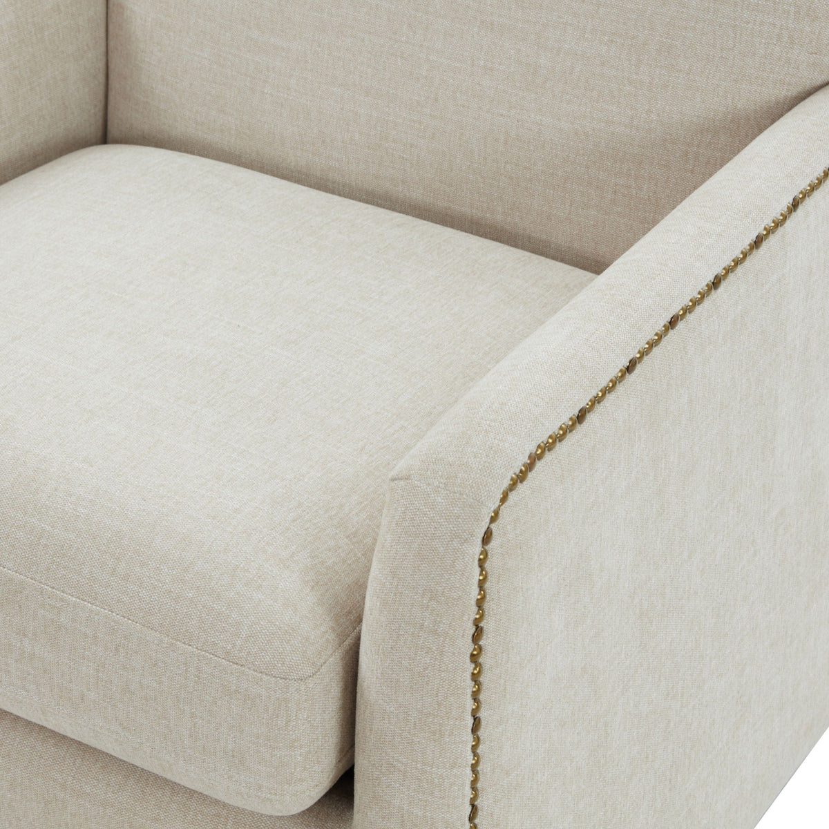 Swivel accent chair beige upholstery with antique brass nailhead trim along edge on Tampa Home & Garden Store