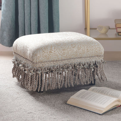 Handcrafted footstool ottoman with wood frame in beige pearl patterned fabric and tassel fringe on Tampa Home & Garden Store
