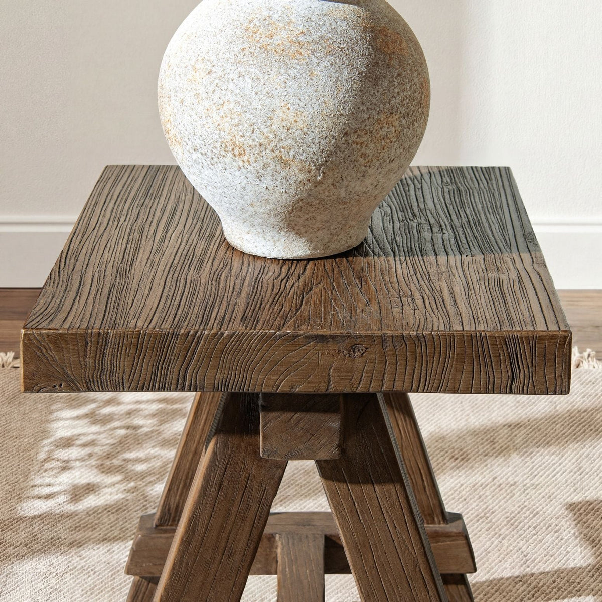Trestle coffee table in dark reclaimed elm with pronounced grain and sturdy angled legs on Tampa Home & Garden Store