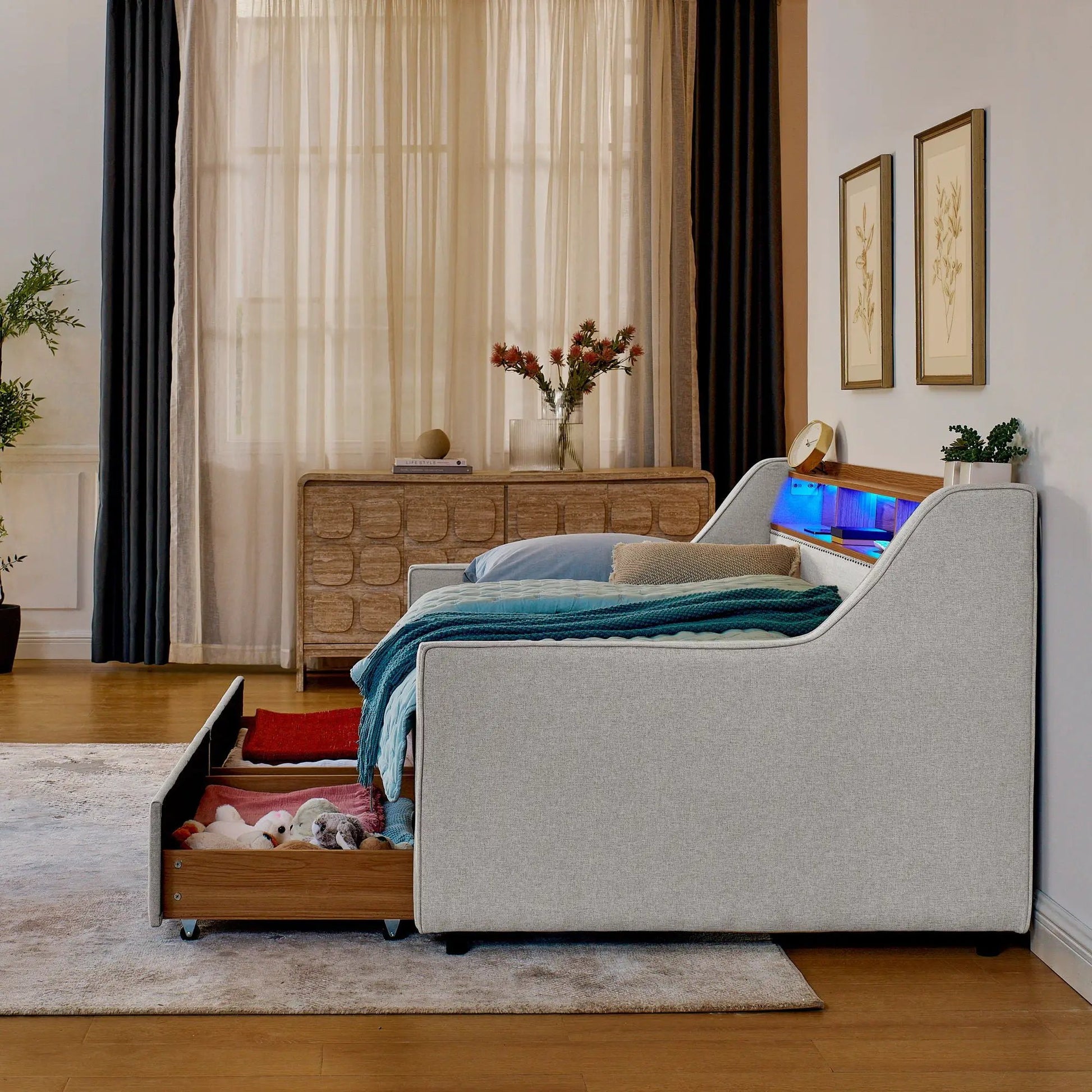 Twin beige upholstered storage beds with open drawers and blue LED lighting in a modern bedroom on Tampa Home & Garden Store