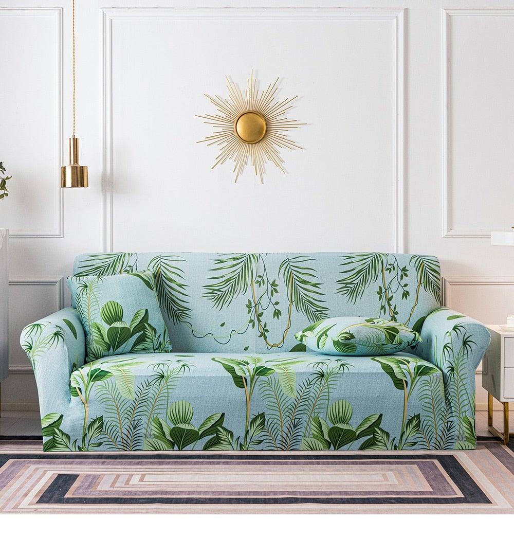 Elastic floral sofa cover with tropical leaf print in light blue by Stevvex; cushion covers on Tampa Home & Garden Store