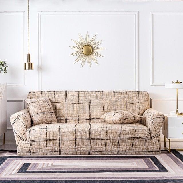 Stevvex elastic sofa cover over a beige plaid sofa in a stylish living room with cushions on Tampa Home & Garden Store