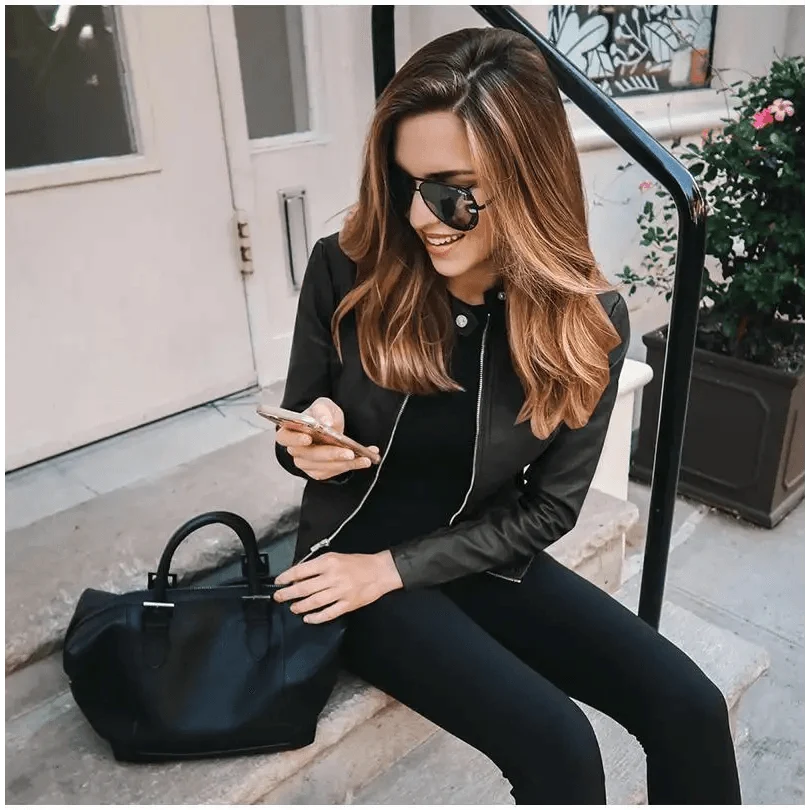 Stevvex women's PU leather jacket solid black worn by a woman with sunglasses on steps on Tampa Home & Garden Store