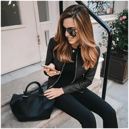 Stevvex women's PU leather jacket solid black worn by a woman with sunglasses on steps on Tampa Home & Garden Store
