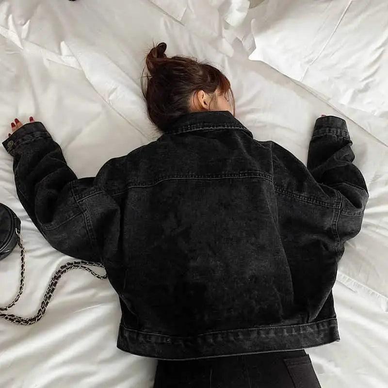 Stevvex black denim short trucker jacket for women, loose fit, back view with a chain bag on Tampa Home & Garden Store