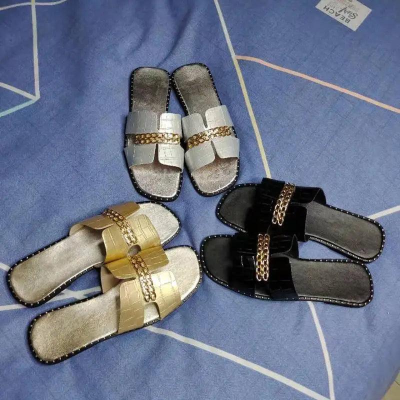 Women chain flip flops with metallic straps; four pairs in silver gold black with chain detail on Tampa Home & Garden Store