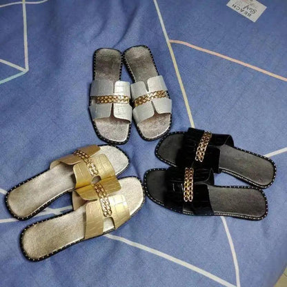 Women chain flip flops with metallic straps; four pairs in silver gold black with chain detail on Tampa Home & Garden Store