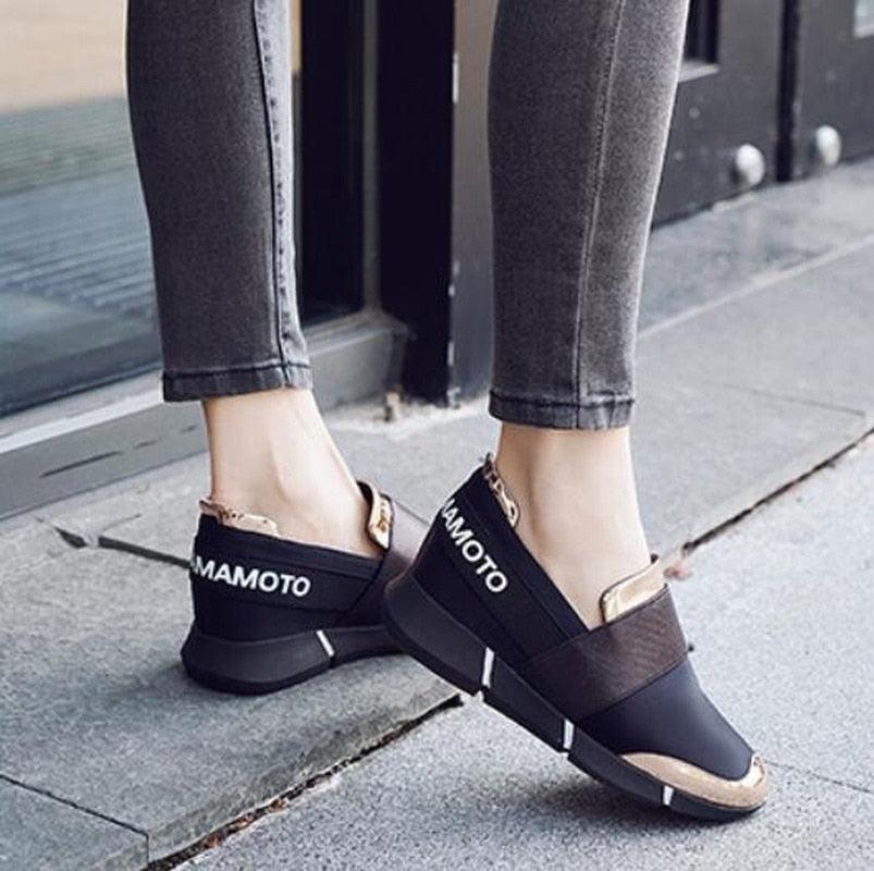 Pair of black Mamoto slip-on sneakers with thick soles and beige toe caps on Tampa Home & Garden Store