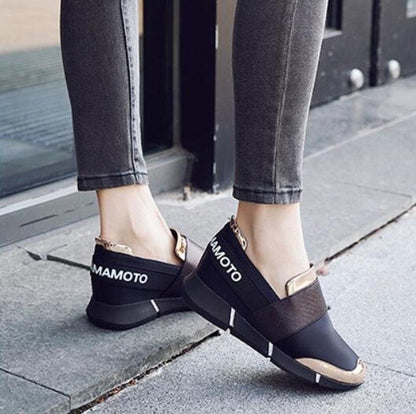 Pair of black Mamoto slip-on sneakers with thick soles and beige toe caps on Tampa Home & Garden Store