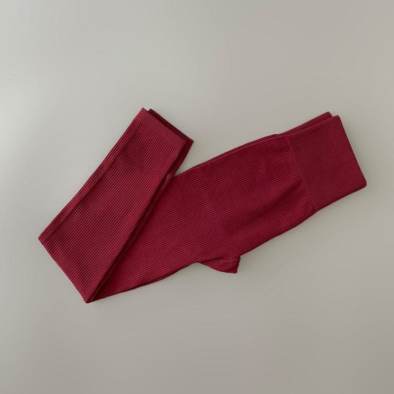 Maroon ribbed yoga leggings folded for workouts on Tampa Home & Garden Store