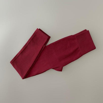 Maroon ribbed yoga leggings folded for workouts on Tampa Home & Garden Store