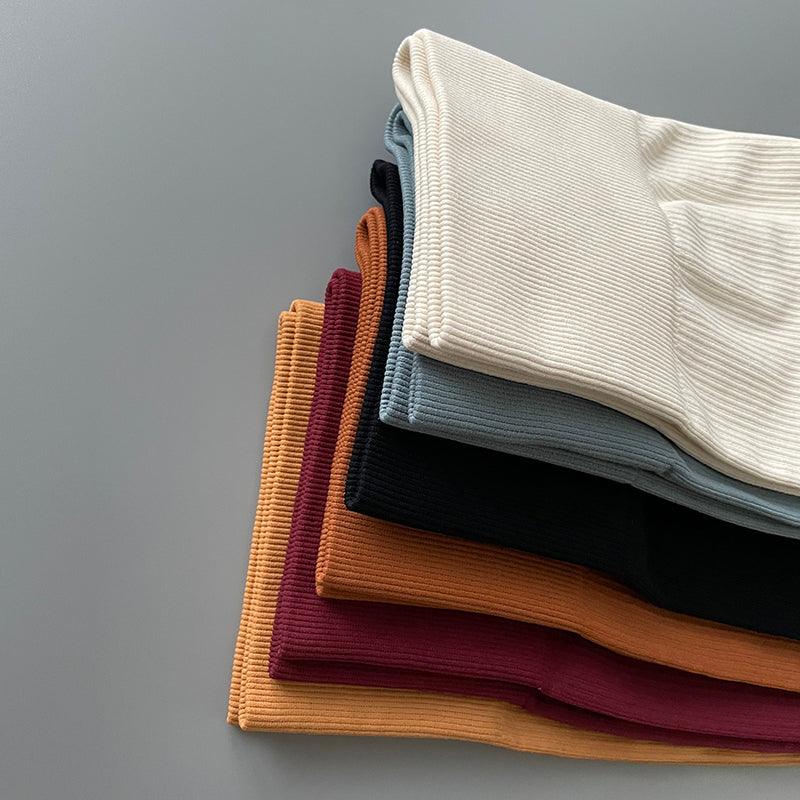 Stevvex leggings folded in assorted colors stacked beige blue gray black orange burgundy on Tampa Home & Garden Store