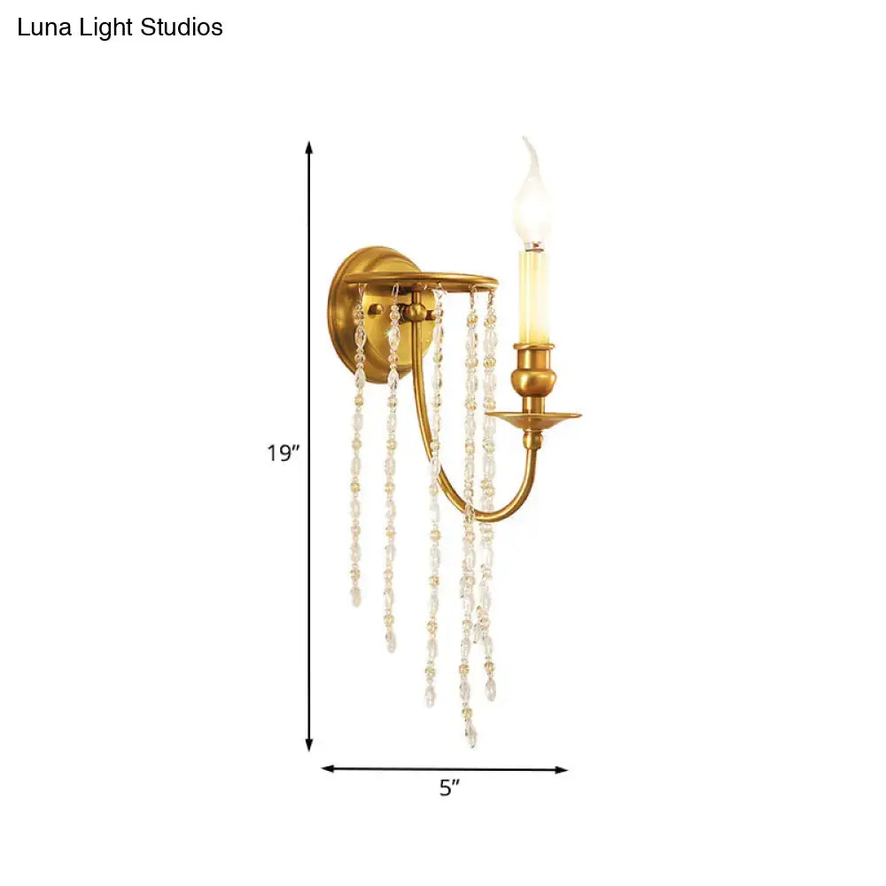 Gold crystal chain design wall sconce with hanging crystal strands and candle-style bulb on Tampa Home & Garden Store