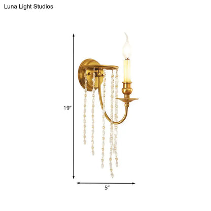 Gold crystal chain design wall sconce with hanging crystal strands and candle-style bulb on Tampa Home & Garden Store
