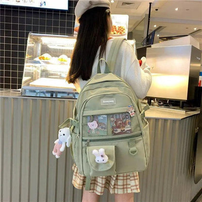 Stevvex school backpack in sage green with mesh pocket and two plush charms on Tampa Home & Garden Store