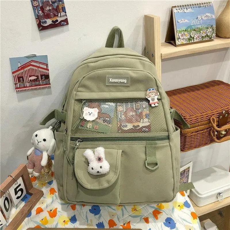 Stevvex olive green school backpack with front mesh pocket and bunny charm, Xuenyang badge on Tampa Home & Garden Store