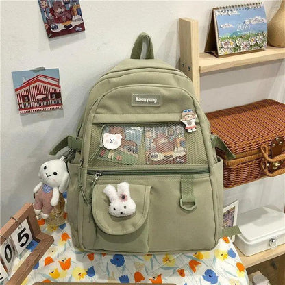 Stevvex olive green school backpack with front mesh pocket and bunny charm, Xuenyang badge on Tampa Home & Garden Store