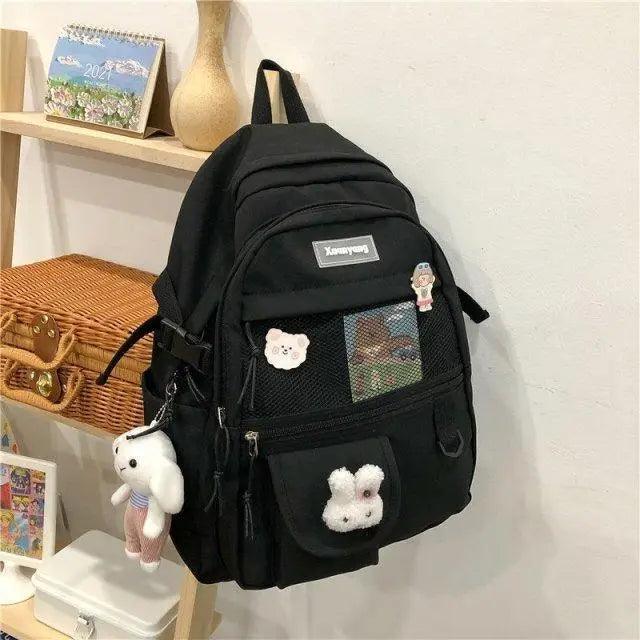 Stevvex black teen backpack with mesh front pocket, bear patches and plush keychains on Tampa Home & Garden Store