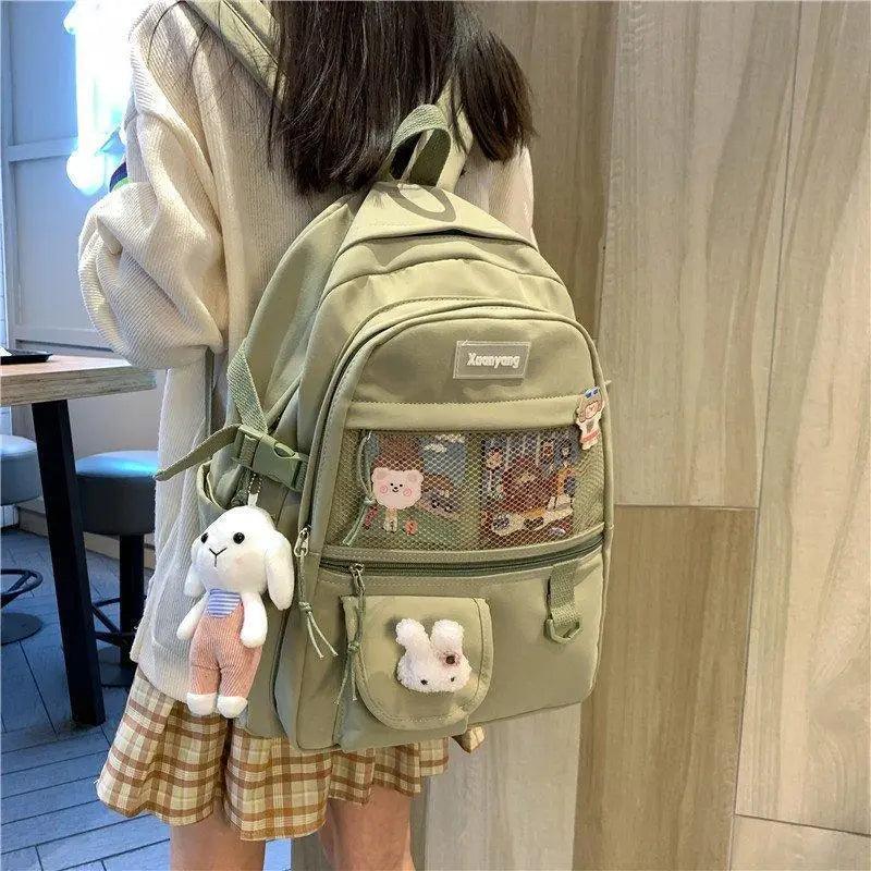 Stevvex olive-green school backpack with mesh front pocket and plush bunny keychain on Tampa Home & Garden Store