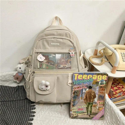 Beige Stevvex ALU92982UVW school backpack with front mesh pocket and plush keychains on Tampa Home & Garden Store