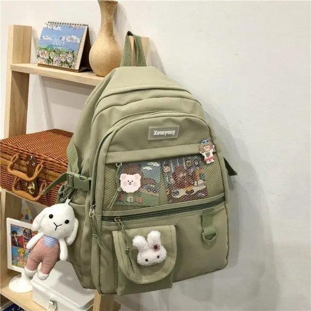Stevvex olive green school backpack with mesh front pocket and plush charms on Tampa Home & Garden Store