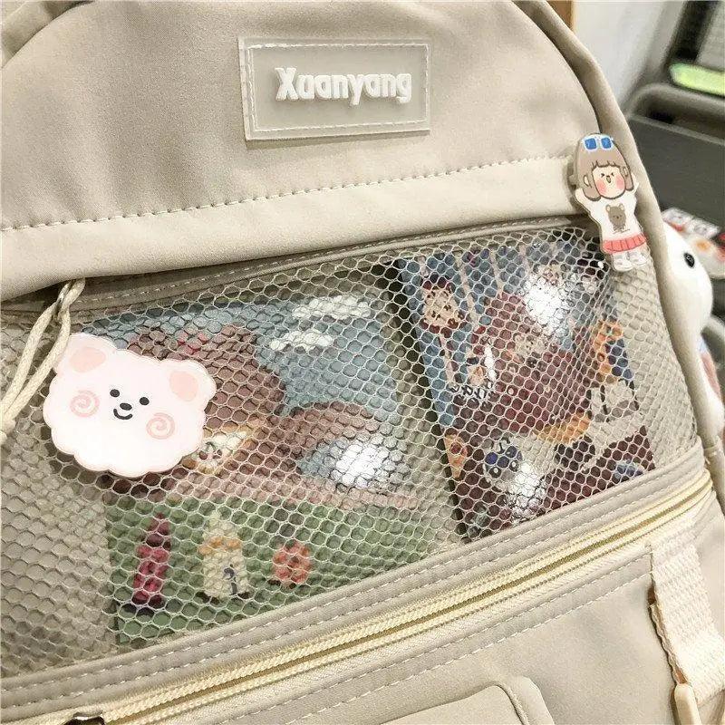 Stevvex beige female school backpack with mesh front pocket and cute cloud and cartoon girl charms on Tampa Home & Garden Store