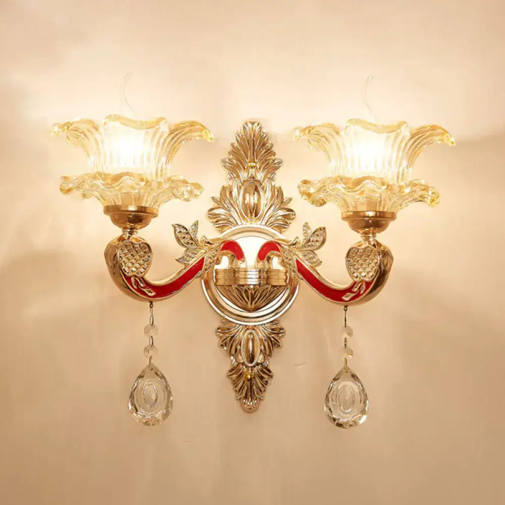 Elegant gold double-arm scrolled wall sconce with crystal prisms by Decorbites on Tampa Home & Garden Store