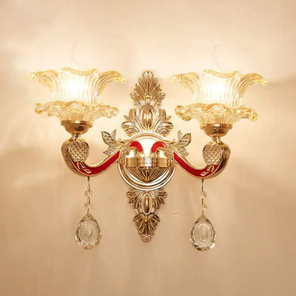 Elegant gold double-arm scrolled wall sconce with crystal prisms by Decorbites on Tampa Home & Garden Store
