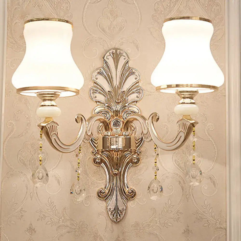 Elegant gold scrolled arm wall sconce by Decorbites with crystal drops and dual white fabric shades on Tampa Home & Garden Store
