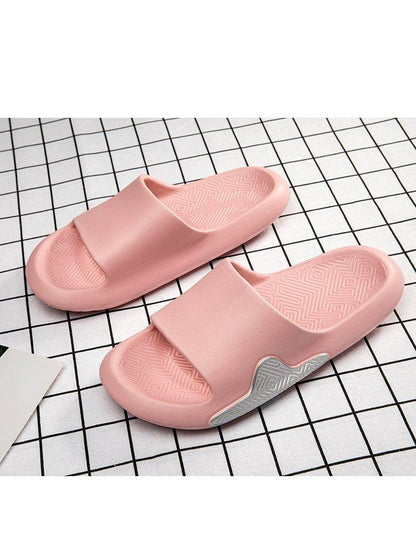 Pair of pink EVA foam slide slippers with textured geometric footbed and anti-slip outsole on Tampa Home & Garden Store