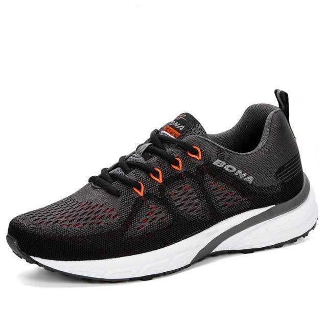 Stevvex men's athletic mesh running shoe in black with orange eyelets and white midsole on Tampa Home & Garden Store