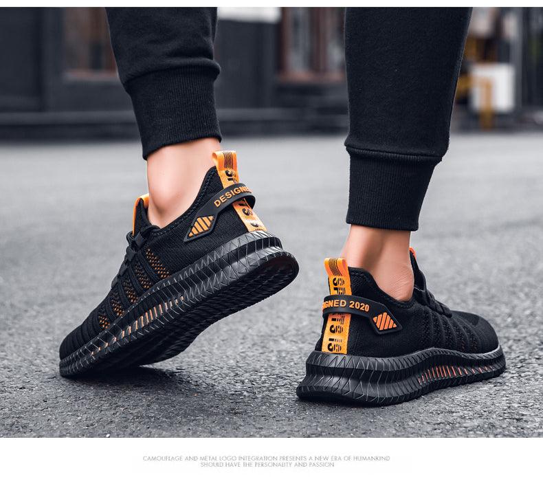 Stevvex men's black running sneakers with orange heel tabs, breathable knit upper and outsole on Tampa Home & Garden Store