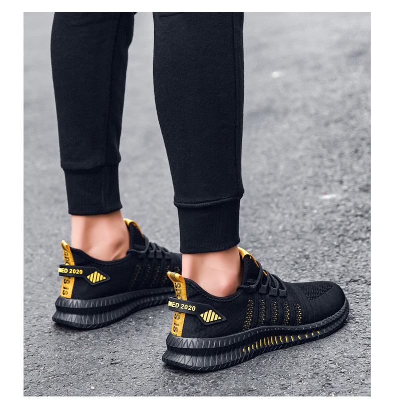 Stevvex men's sneakers ST85SH3255GHR black knit upper with yellow heel tabs on pavement on Tampa Home & Garden Store