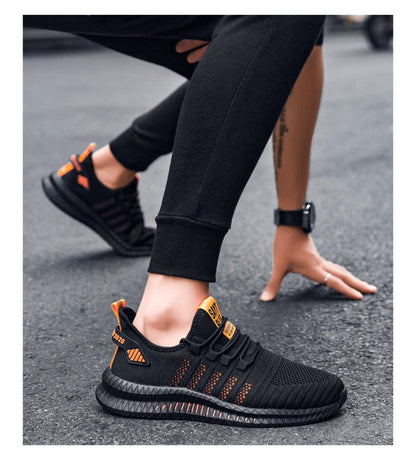 Stevvex men's running sneakers pair, black with orange accents, breathable mesh upper on Tampa Home & Garden Store