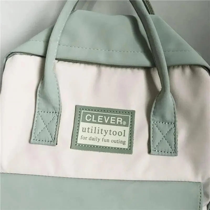 Mint nylon school backpack with pastel color blocks and a CLEVER utilitytool patch on Tampa Home & Garden Store