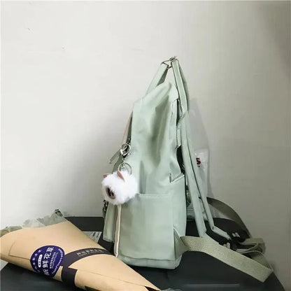 Stevvex mint green nylon school backpack with fluffy white pom keychain on Tampa Home & Garden Store