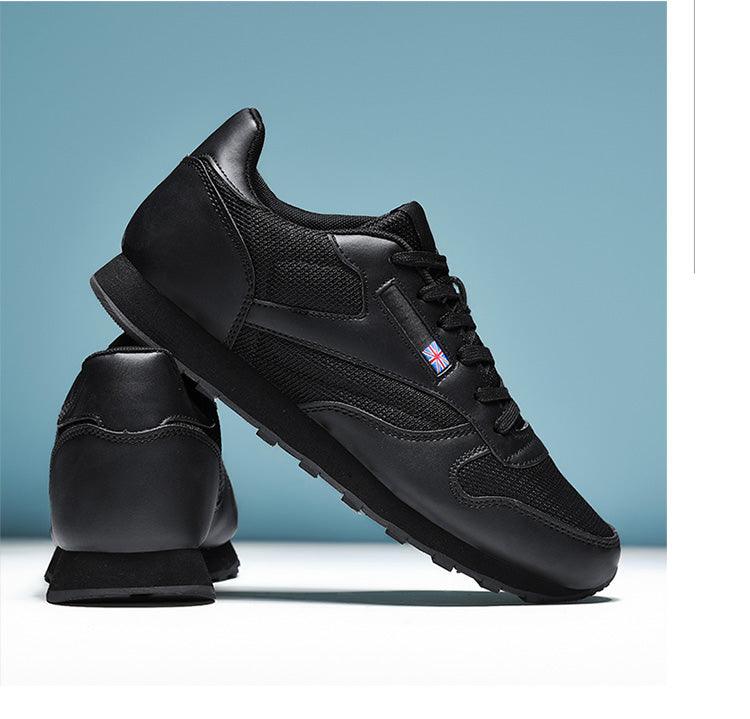 Stevvex black sneakers with mesh panels, lace-up front, and rugged sole; UK flag badge on side on Tampa Home & Garden Store