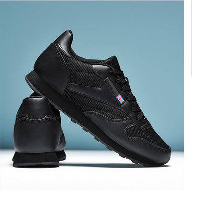 Stevvex black sneakers with mesh panels, lace-up front, and rugged sole; UK flag badge on side on Tampa Home & Garden Store