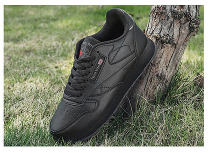 Stevvex black leather sneakers lace-up training shoes on grass beside a tree on Tampa Home & Garden Store