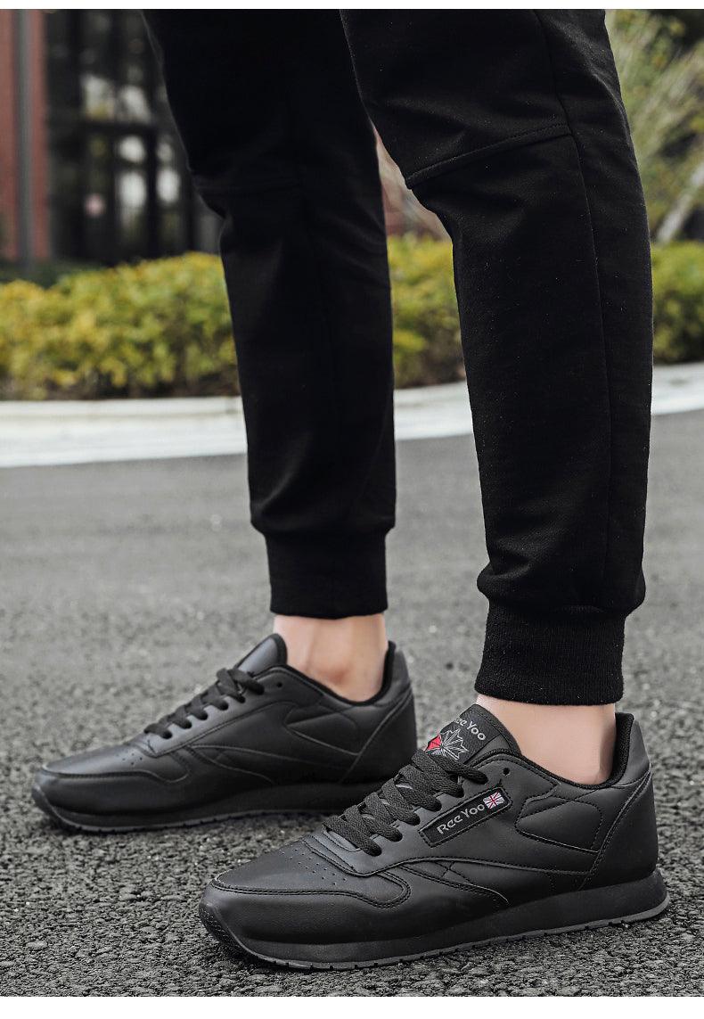 Stevvex black leather sneakers with lace-up closure, low-profile athletic trainers on pavement on Tampa Home & Garden Store