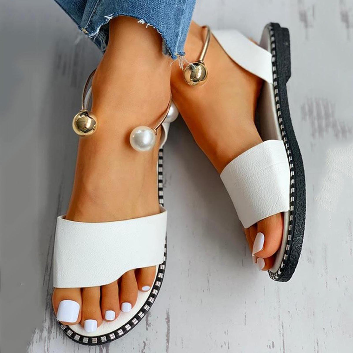 Stevvex white sandals with wide strap and pearl buckle ankle detail, black-trimmed sole on Tampa Home & Garden Store