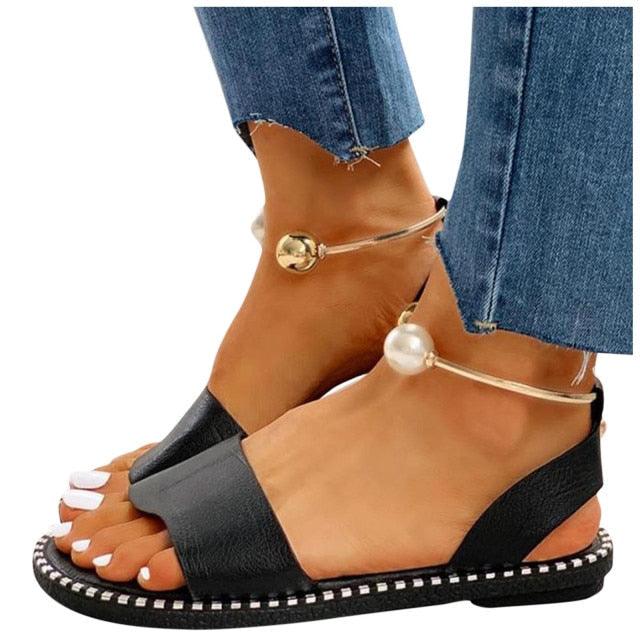 Women's black toe-strap sandals with pearl and gold bead ankle straps and stitched sole on Tampa Home & Garden Store