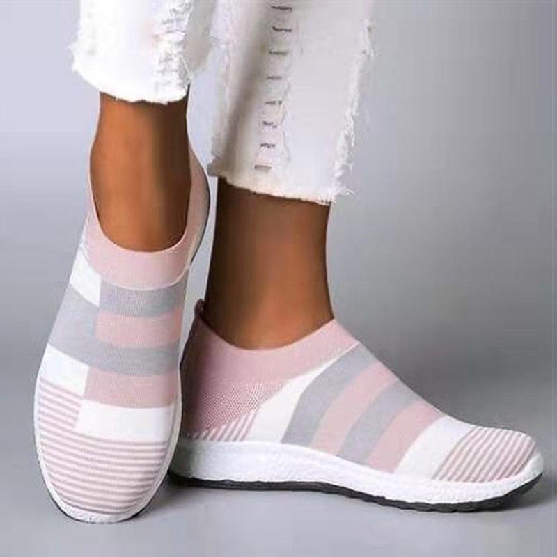 Women’s knitted slip-on sneakers in pastel pink and gray stripes with a white rubber sole on Tampa Home & Garden Store