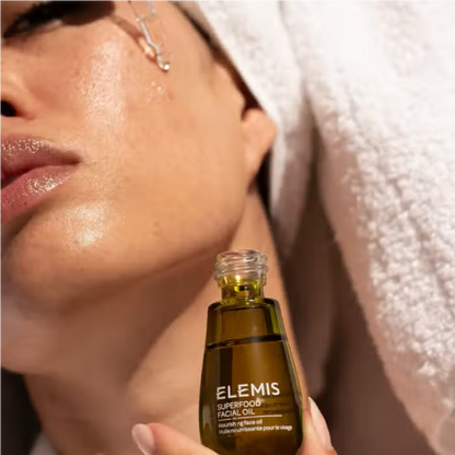 Elemis Superfood Facial Oil 15ml amber glass bottle held near the face on Tampa Home & Garden Store