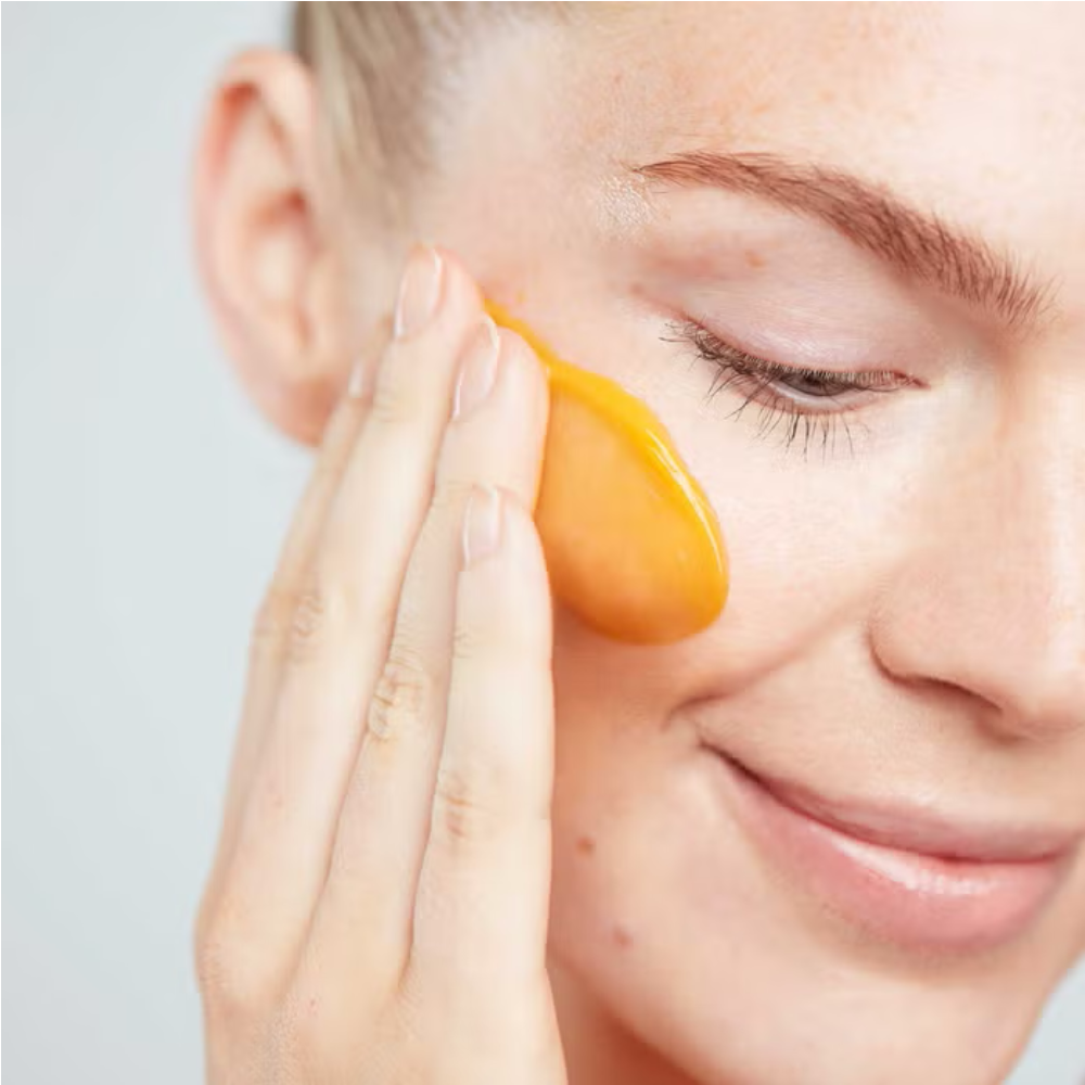 Elemis Superfood Glow Cleansing Butter 90 ml orange cleansing balm applied to cheek on Tampa Home & Garden Store