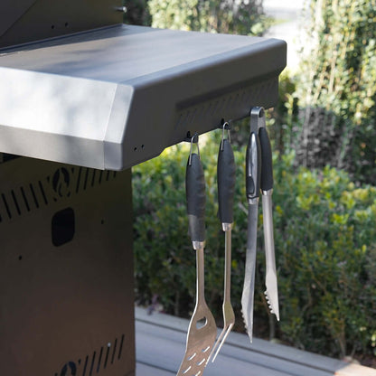 Eminence 425 6-burner outdoor grill in stainless steel with four hanging utensils on Tampa Home & Garden Store