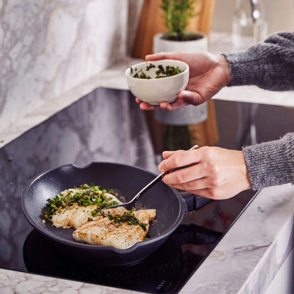 Ceramic Nonstick Whole Fish Pan by Alva Cookware with herb garnish frying on stove on Tampa Home & Garden Store