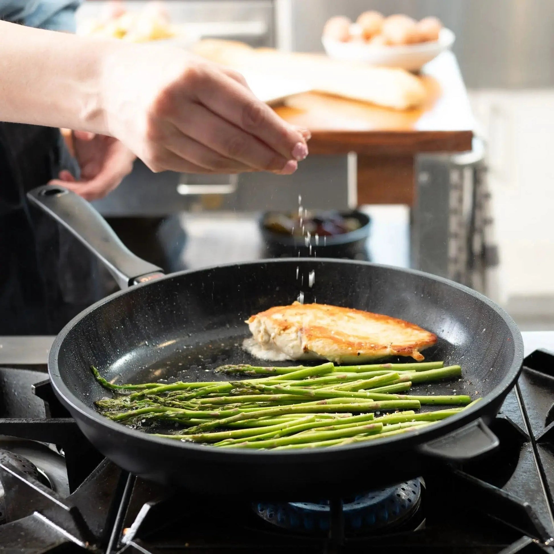Ceramic Nonstick Frying Pan by Alva Cookware with two browned patties and asparagus on Tampa Home & Garden Store